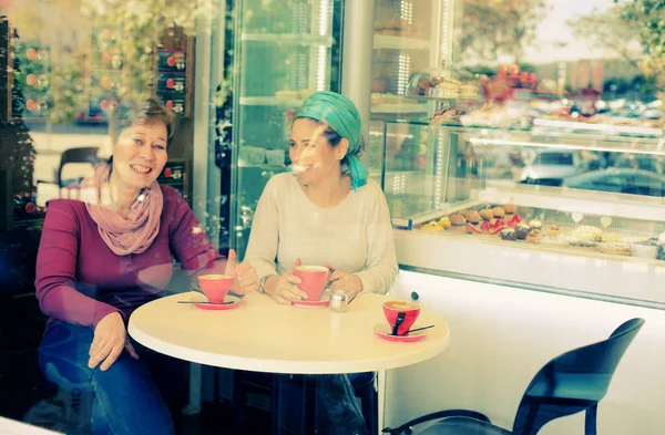 happy women sitting in cafe