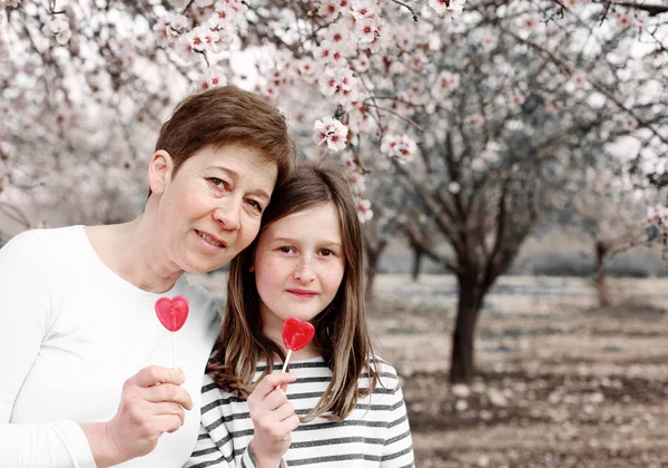 Mother and daughter in blooming park — Stock Photo, Image