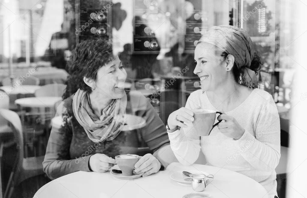 happy women sitting in cafe
