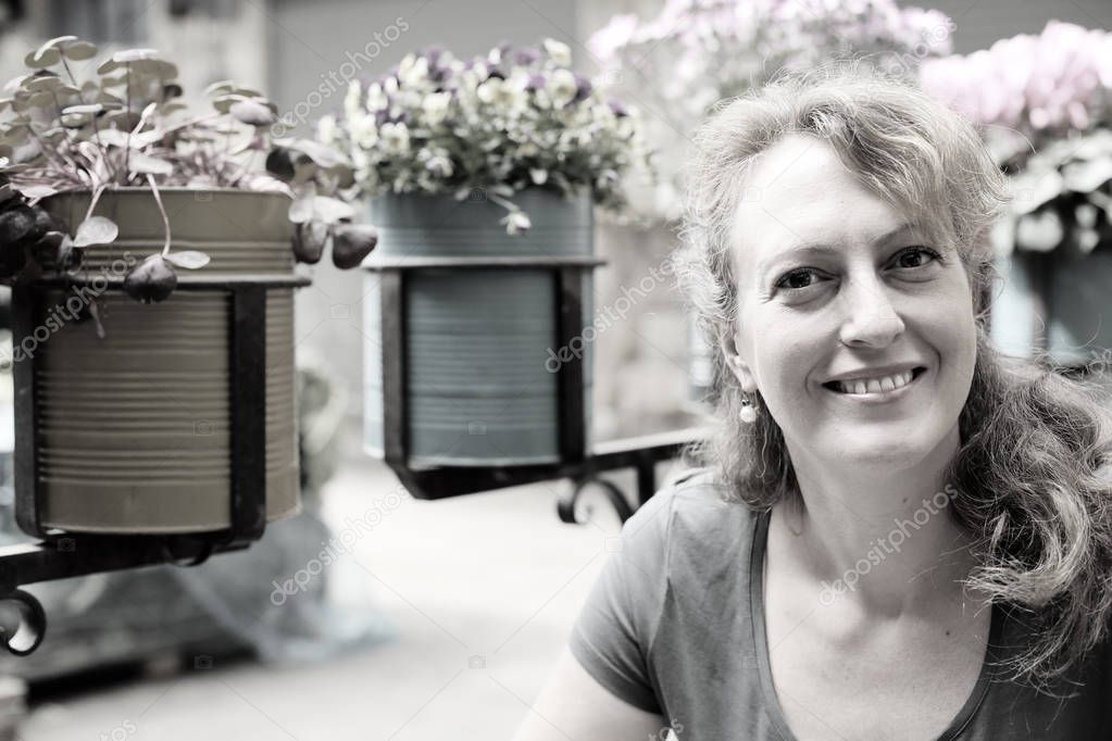 mature woman sitting in outdoor cafe