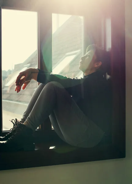 Woman looking throught window — Stock Photo, Image