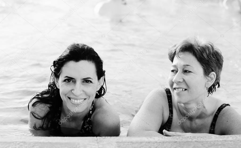 Portrait of two women in swimming pool 