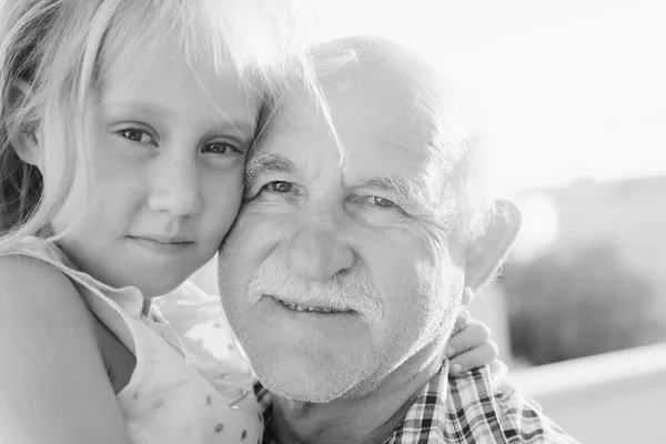 Grandfather holding granddaughter — Stock Photo, Image