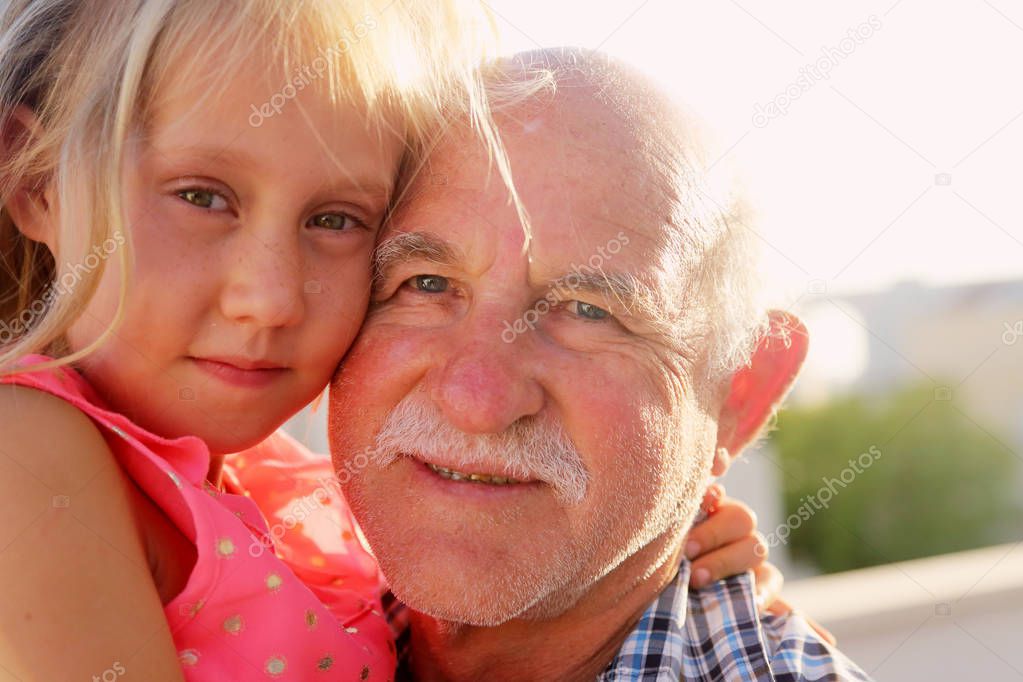 Grandfather holding granddaughter