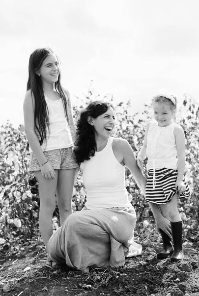 Portrait of beautiful mother with two daughters outdoors — Stock Photo, Image