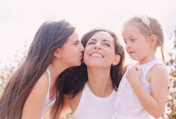 Portrait of beautiful mother with two daughters outdoors — Stock Photo, Image