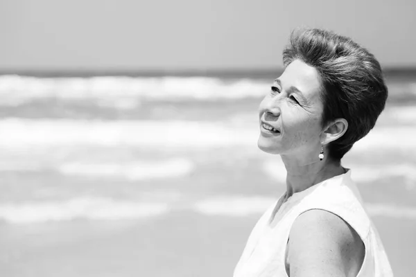 Mature woman on sandy beach — Stock Photo, Image