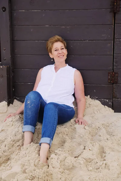 Mature woman on sandy beach — Stock Photo, Image