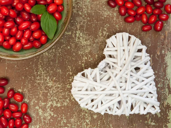 Berries and white colored heart shape — Stock Photo, Image