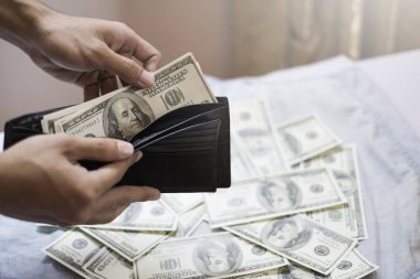 elinde dolarla siyah cüzdan