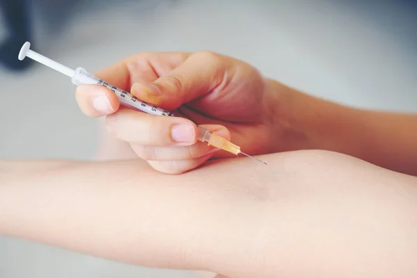 Syringe, medical injection in hand, palm or fingers. Medicine pl