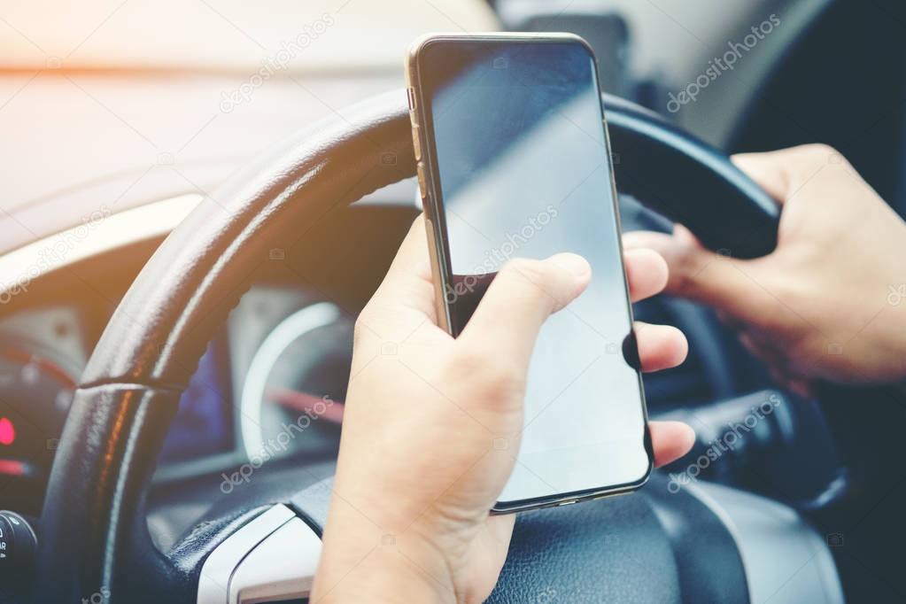 Driving while holding a mobile phone to work ,businessman ,vinta