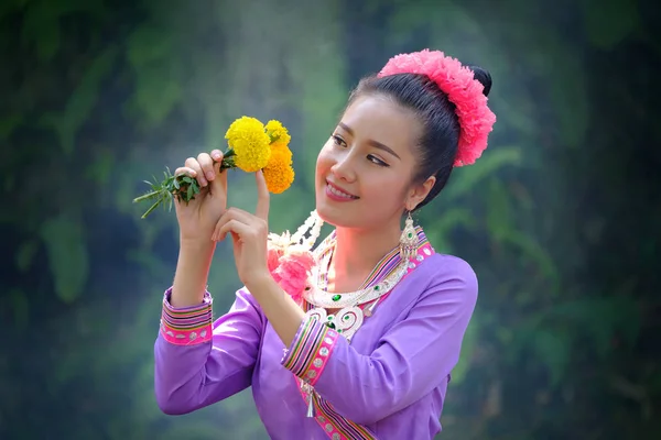 Beautiful Asian woman flower on hand with Thai traditional dress