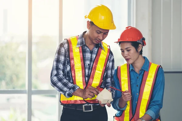 Engineers are meeting, working and looking at Home model in the — Stock Photo, Image