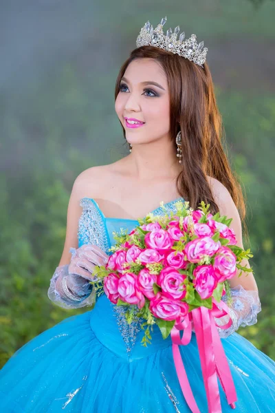 Beautiful Asian woman flower bouquet on hand with traditional dr