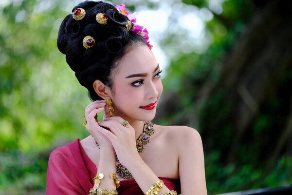 Beautiful Thai girl in traditional dress costume as Thai temple 