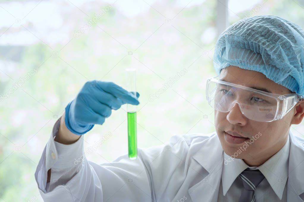 Young male scientist standing in lab worker making medical resea