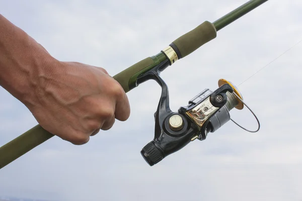 Fishing Spinning in hand — Stock Photo, Image
