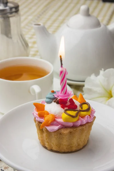 Cake with a candle on whte plate — Stock Photo, Image