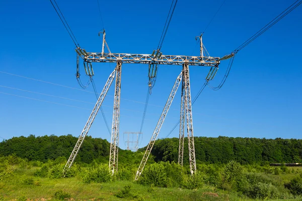 Power lines in a green field — Stock Photo, Image