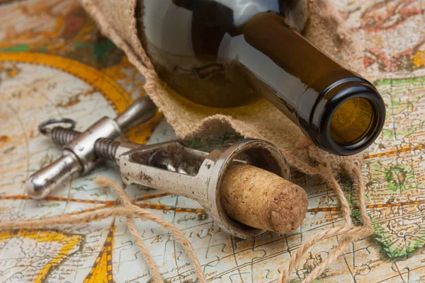 Bottle of wine and old corkscrew — Stock Photo, Image