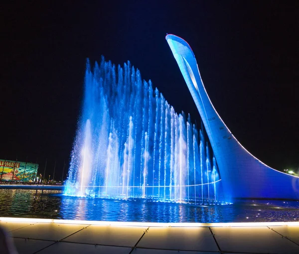 Bowl of the Olympic flame "Firebird" and singing Fountain in the — Stock Photo, Image