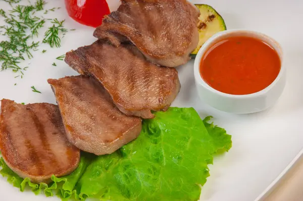 Boiled beef tongue with vegetables is served on a plate — Stock Photo, Image