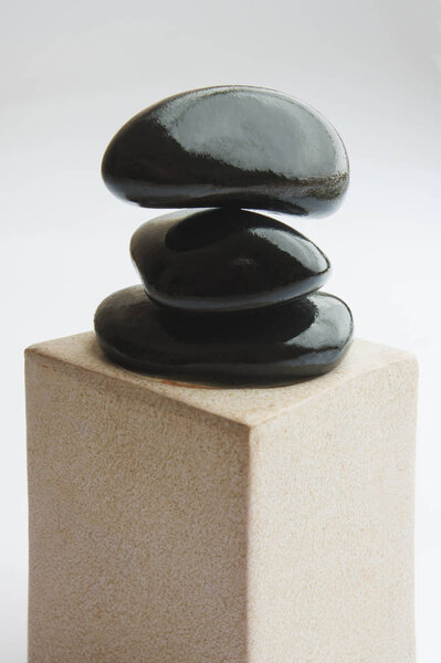 Spa with black stones on a white background
