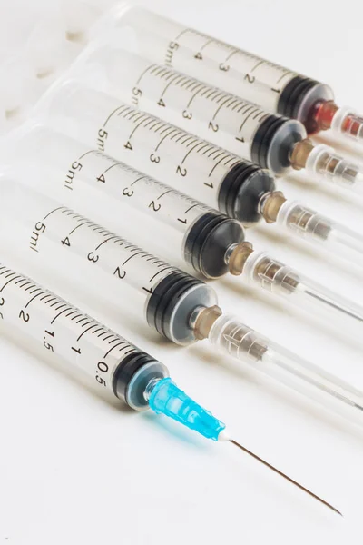 Disposable syringe in the row — Stock Photo, Image