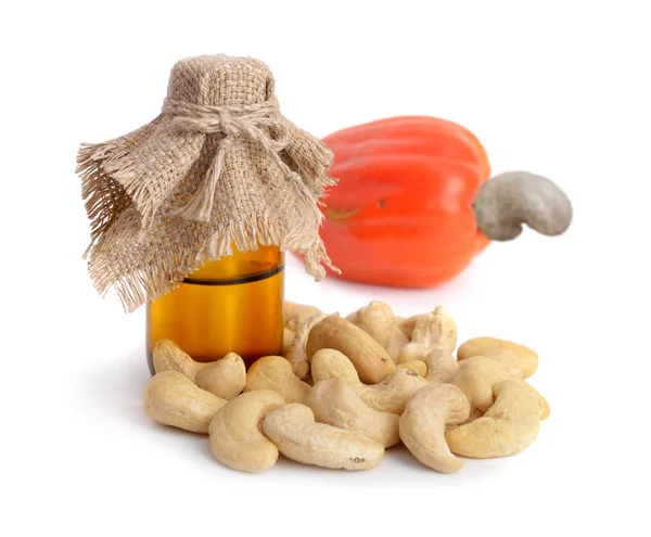 Cashew oil with apple and nuts. — Stock Photo, Image