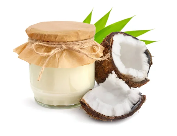 Jar of coconut oil and fresh coconuts — Stock Photo, Image