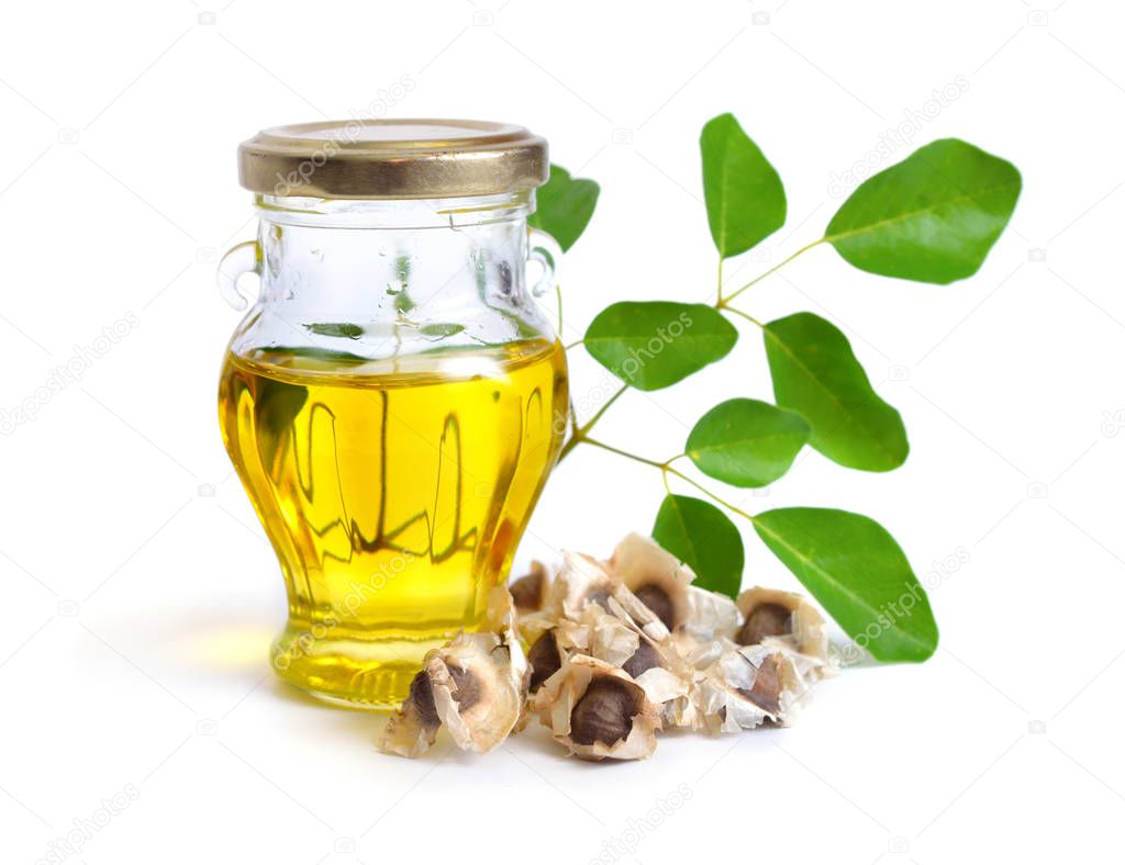 Moringa oleifera oil with seeds and leawes. Isolated on white ba