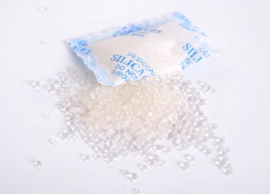 Silicagel pellets and bag on white background clipart