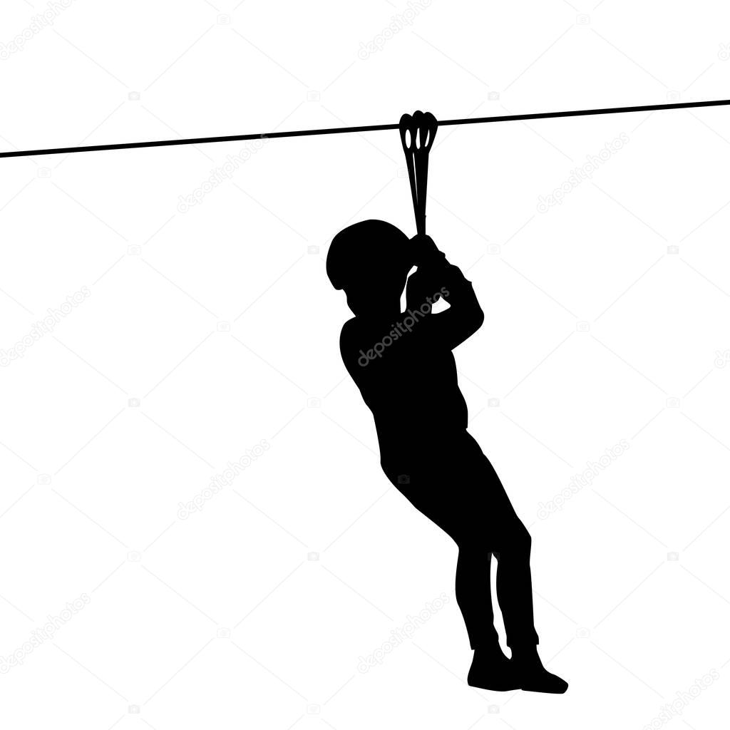 Silhouette of a kid playing with a tyrolean traverse