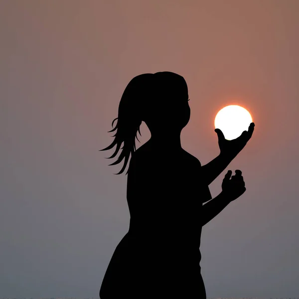 Ragazza silhouette tenendo il sole nelle sue mani — Foto Stock