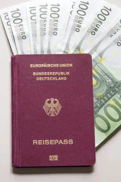 German international traveling passport and euro money.