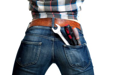 Sexy ass covered with tight blue jeans, back pocket screwdriver and wrench