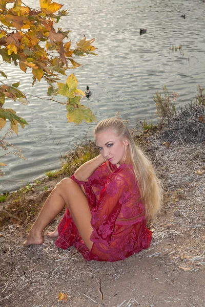 Blond girl by a lake — Stock Photo, Image