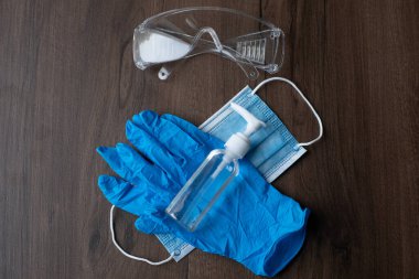 Corona covid virüsleri - chirurgical maske, eldivenler, bardaklar ve şişeler ve masada alkol ve sıvı sabun