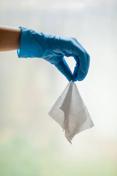 Wet Wipes Should be Thrown in the Trash - not in the sawer. Hand in blue protective glove