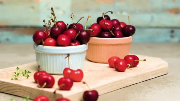 Red ripe cherries in ceramic bowls — Stock Video