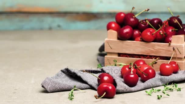 Red ripe cherries in small wooden box — Stock Video