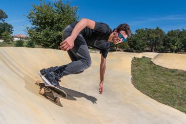 Skateboarder on a pump track park clipart