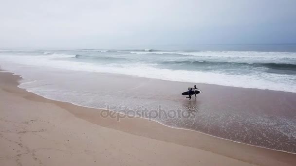 Young couple of friendly surfers wearing wetsuit — Stock Video