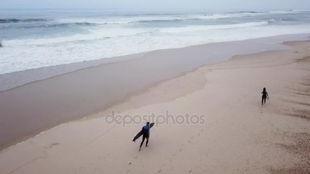 Young couple of friendly surfers wearing wetsuit — Stock Video