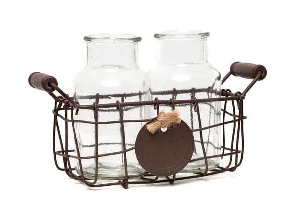 Two empty glass bottless in a vintage wire basket — Stock Photo, Image