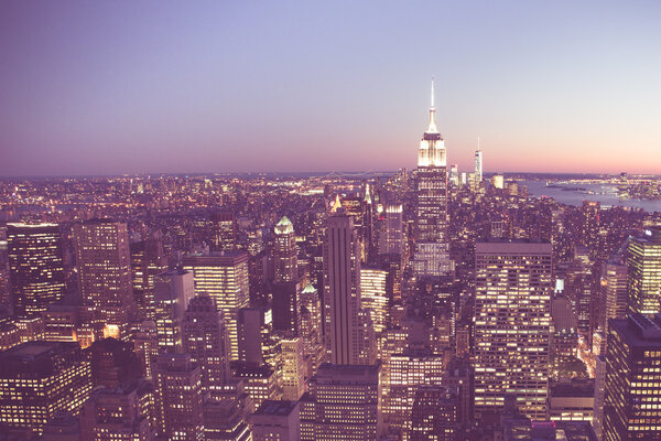 Vintage tone image of New York City at sunset with buildings and lights