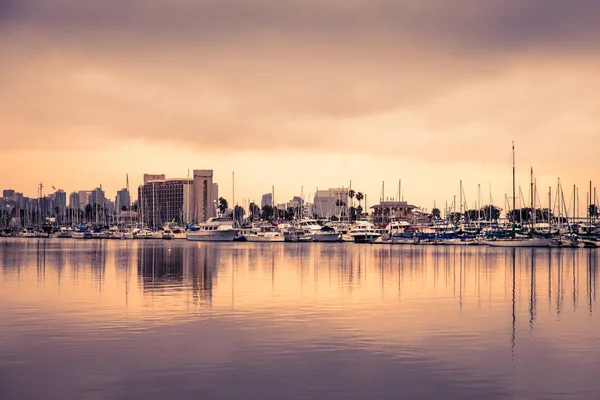 View of San Diego California at sunset with boats and buildings seen across the water