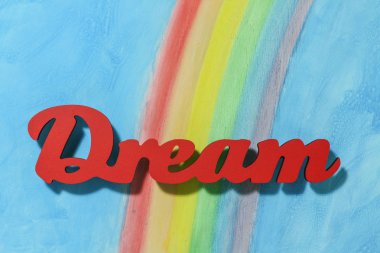 Renkli gökkuşağı ve mavi gökyüzü arka plan ile kelime rüya