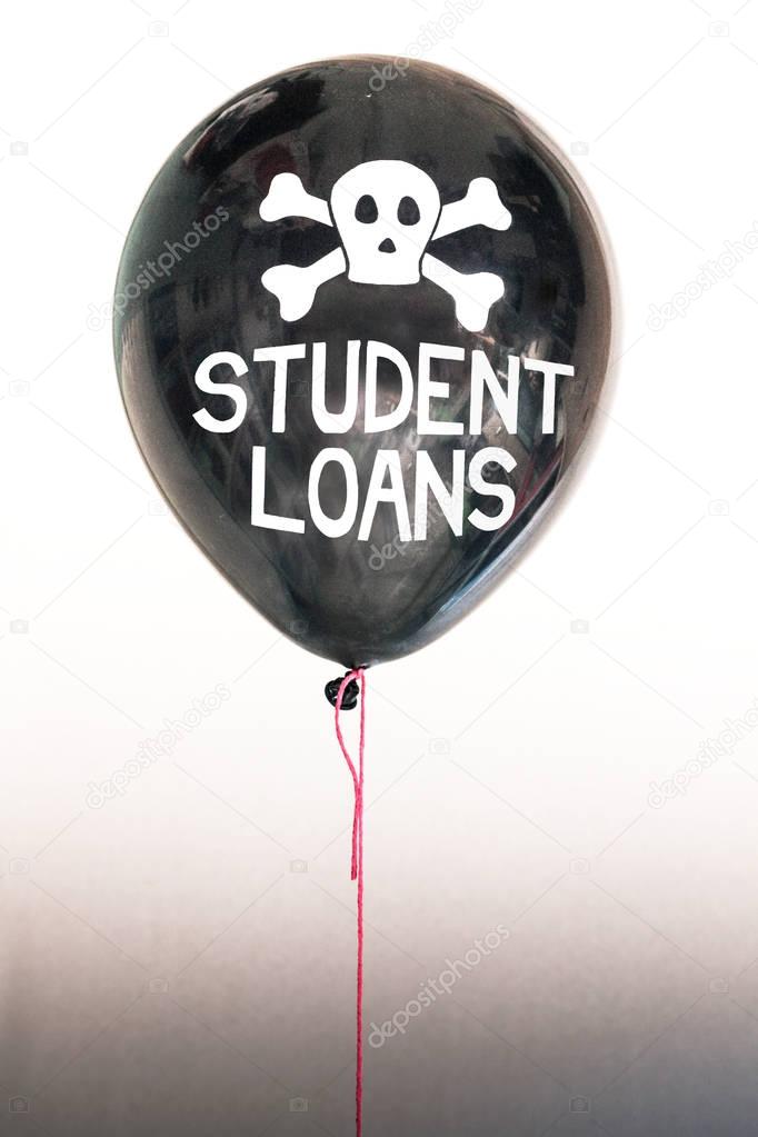 The words student loans in white and a skull and cross bones on a balloon illustrating the concept of a debt bubble